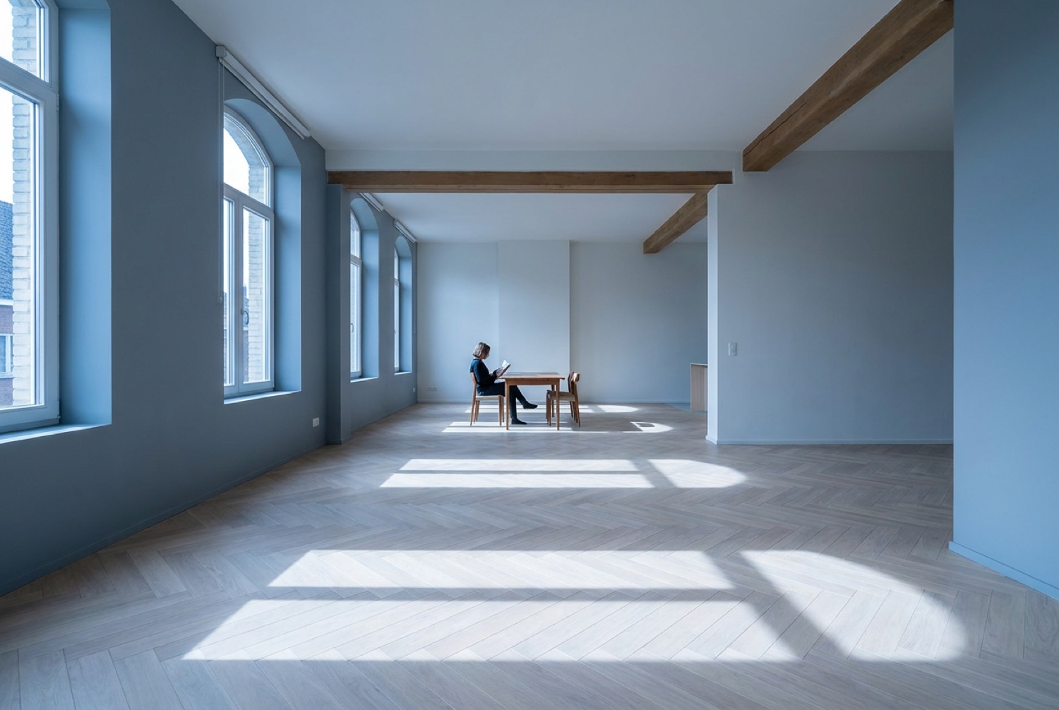 A person working calmly at a table in a bright room